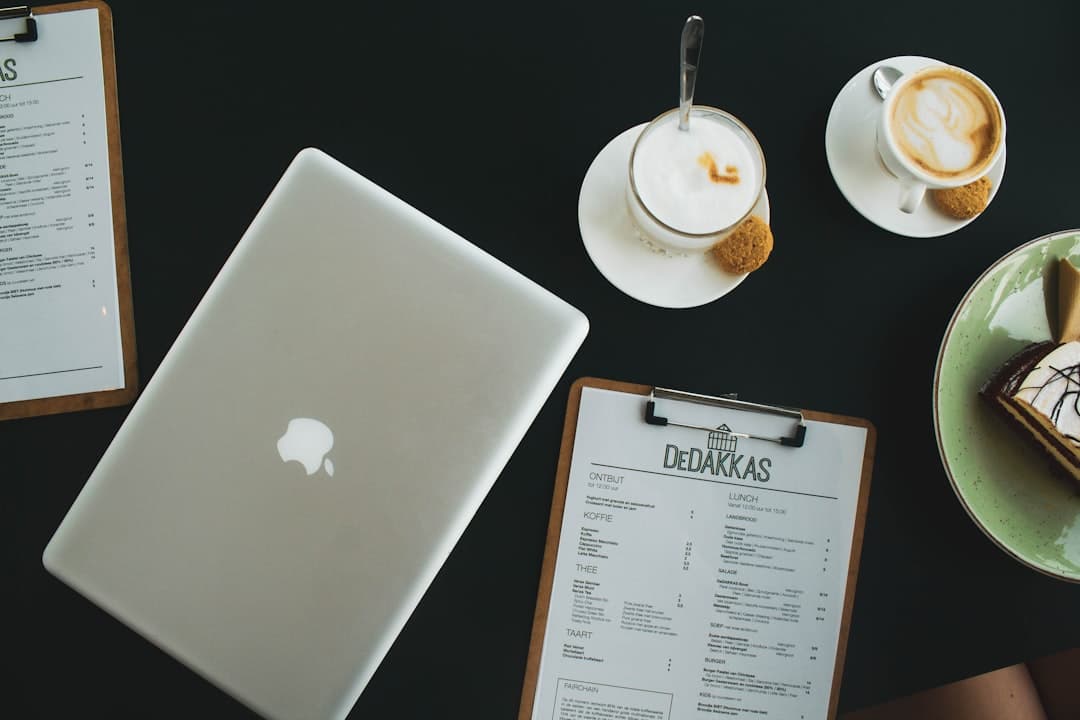 website laten maken haarlem — silver macbook beside white ceramic teacup on saucer